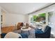 Bright living room showcasing hardwood floors, a large window, and comfortable seating at 1370 S Hudson St, Denver, CO 80222