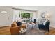 Inviting living room featuring a large window offering ample natural light and stylish decor at 1370 S Hudson St, Denver, CO 80222