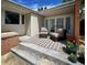 Cozy outdoor seating area with comfortable chairs, stylish rug, and colorful potted plants on patio at 1370 S Hudson St, Denver, CO 80222