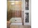 Tiled shower with glass door complemented by unique cabinetry, adding character to the bathroom at 1370 S Hudson St, Denver, CO 80222