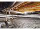 Unfinished basement with exposed ceiling and a moisture barrier laid over the floor at 2226 Monte Vista St, Fort Lupton, CO 80621
