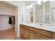 Well-lit bathroom with double vanity, modern fixtures, and a separate closet space at 2226 Monte Vista St, Fort Lupton, CO 80621