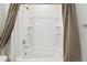 The bathroom features a shower-tub combination with tile surround and built-in shelving at 2226 Monte Vista St, Fort Lupton, CO 80621