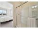 Bright bathroom features a glass shower and a glimpse into the Primary bedroom at 2226 Monte Vista St, Fort Lupton, CO 80621