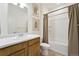Bright bathroom featuring a vanity with a white countertop and a shower-tub combination with a curtain at 2226 Monte Vista St, Fort Lupton, CO 80621
