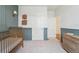 Bedroom view showing closet and dresser, enhanced by a gold crib at 2226 Monte Vista St, Fort Lupton, CO 80621