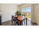 Bright dining area featuring a wooden table with seating for four, next to sliding glass doors to outside at 2226 Monte Vista St, Fort Lupton, CO 80621