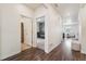 Bright hallway with wood floors that connects to a well-lit living area and a bedroom at 2226 Monte Vista St, Fort Lupton, CO 80621