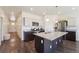 Elegant kitchen with a large island, stainless steel appliances, and dark wood floors at 2226 Monte Vista St, Fort Lupton, CO 80621
