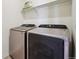 The laundry room features a side-by-side washer and dryer and a shelf for storage at 2226 Monte Vista St, Fort Lupton, CO 80621