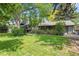 Expansive backyard featuring mature trees, a deck, covered patio and a lush lawn at 5050 W 102 Ave, Westminster, CO 80031