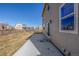 Backyard with concrete patio and a fenced lawn at 579 Jewel St, Brighton, CO 80603