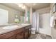 Bathroom featuring dual sinks, tiled floors, and a shower-tub combination at 579 Jewel St, Brighton, CO 80603