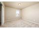 Bright bedroom features neutral carpeting, a window, and a closet at 579 Jewel St, Brighton, CO 80603