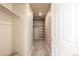 Walk-in closet featuring built-in shelving, ample hanging space, and neutral carpeting at 579 Jewel St, Brighton, CO 80603