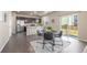 Modern dining area with a view of the kitchen and a seamless transition to the backyard patio at 579 Jewel St, Brighton, CO 80603