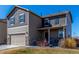 Attractive two-story home featuring stone accents, an attached garage, and a covered front porch at 579 Jewel St, Brighton, CO 80603