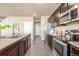 Modern kitchen showcasing stainless steel appliances, dark cabinetry, and light countertops at 579 Jewel St, Brighton, CO 80603