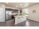 Bright kitchen features stainless steel appliances, dark wood cabinets, light countertops, and a stylish island at 579 Jewel St, Brighton, CO 80603