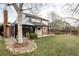 Expansive backyard with lush lawn, mature trees, and a charming sunroom addition at 8856 W Prentice Ave, Littleton, CO 80123