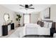 This bedroom features neutral paint, carpet, a ceiling fan, and a plant in the corner at 8856 W Prentice Ave, Littleton, CO 80123