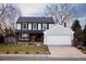 Charming two-story home featuring a well-manicured front yard and attached two-car garage at 8856 W Prentice Ave, Littleton, CO 80123