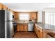 Kitchen featuring stainless steel appliances, modern countertops, and wooden cabinetry at 8856 W Prentice Ave, Littleton, CO 80123