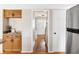 Kitchen with stainless steel refrigerator and pantry near the hallway at 8856 W Prentice Ave, Littleton, CO 80123