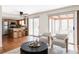 Inviting living room featuring hardwood floors, kitchen island, and access to a sunroom at 8856 W Prentice Ave, Littleton, CO 80123