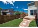 Inviting backyard with artificial turf, stepping stone path, and wooden deck at 9781 Dunning Cir, Highlands Ranch, CO 80129