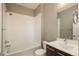 Bathroom featuring tiled shower-tub, toilet, vanity and sink with dark wood cabinetry at 9781 Dunning Cir, Highlands Ranch, CO 80129