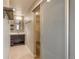 Modern bathroom featuring floating vanity and open sliding closet with shelving and hanging rods at 9781 Dunning Cir, Highlands Ranch, CO 80129