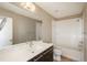 Bathroom with a modern vanity, large mirror, and a shower-tub combination with tiled walls at 9781 Dunning Cir, Highlands Ranch, CO 80129