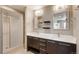 Bathroom with double vanity, stylish lighting, and glass shower at 9781 Dunning Cir, Highlands Ranch, CO 80129