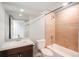Bathroom featuring tiled walls, modern sink and vanity, toilet, and shower-tub combo at 9781 Dunning Cir, Highlands Ranch, CO 80129