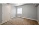 Neutral bedroom featuring carpet, a window, and a white door at 9781 Dunning Cir, Highlands Ranch, CO 80129