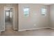 Bedroom featuring neutral colored walls and carpet with two windows at 9781 Dunning Cir, Highlands Ranch, CO 80129