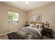 Cozy bedroom with a large window, a comfortable bed with stylish linens, and modern furnishings at 9781 Dunning Cir, Highlands Ranch, CO 80129