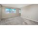 Bedroom with neutral colored walls and carpet featuring three windows at 9781 Dunning Cir, Highlands Ranch, CO 80129