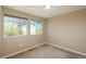 Comfortable carpeted bedroom featuring two windows providing exterior views and natural light at 9781 Dunning Cir, Highlands Ranch, CO 80129