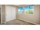 Bedroom with a pair of windows, sliding-door closet, neutral walls and carpeted flooring at 9781 Dunning Cir, Highlands Ranch, CO 80129