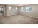 Large bonus room featuring neutral colored walls and carpet with three windows at 9781 Dunning Cir, Highlands Ranch, CO 80129