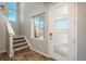 Bright entryway featuring a modern front door, wood floors, and staircase at 9781 Dunning Cir, Highlands Ranch, CO 80129