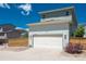 A quaint two-car garage provides convenient parking and complements the lovely home's exterior at 9781 Dunning Cir, Highlands Ranch, CO 80129