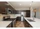 Well-equipped kitchen featuring stainless steel appliances, a large island, and sleek dark cabinets at 9781 Dunning Cir, Highlands Ranch, CO 80129