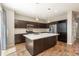 Modern kitchen with dark cabinetry, a spacious island, stainless steel appliances, and stylish pendant lighting at 9781 Dunning Cir, Highlands Ranch, CO 80129