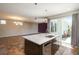 Modern kitchen with stainless steel appliances, a spacious island, and access to the outdoor space through sliding glass doors at 9781 Dunning Cir, Highlands Ranch, CO 80129