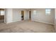 Large main bedroom with neutral walls and carpeting, with laundry closet and natural light from two windows at 9781 Dunning Cir, Highlands Ranch, CO 80129