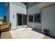 Back patio area with sliding glass door, small wooden deck, and concrete patio at 9781 Dunning Cir, Highlands Ranch, CO 80129