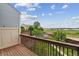 Relaxing back deck with wood floors and railing, offering picturesque views of the surrounding open space at 1699 S Trenton St # 174, Denver, CO 80231